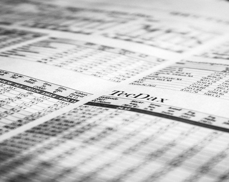 Close-up of a newspaper page with numeric stock data and the TechDay header.
